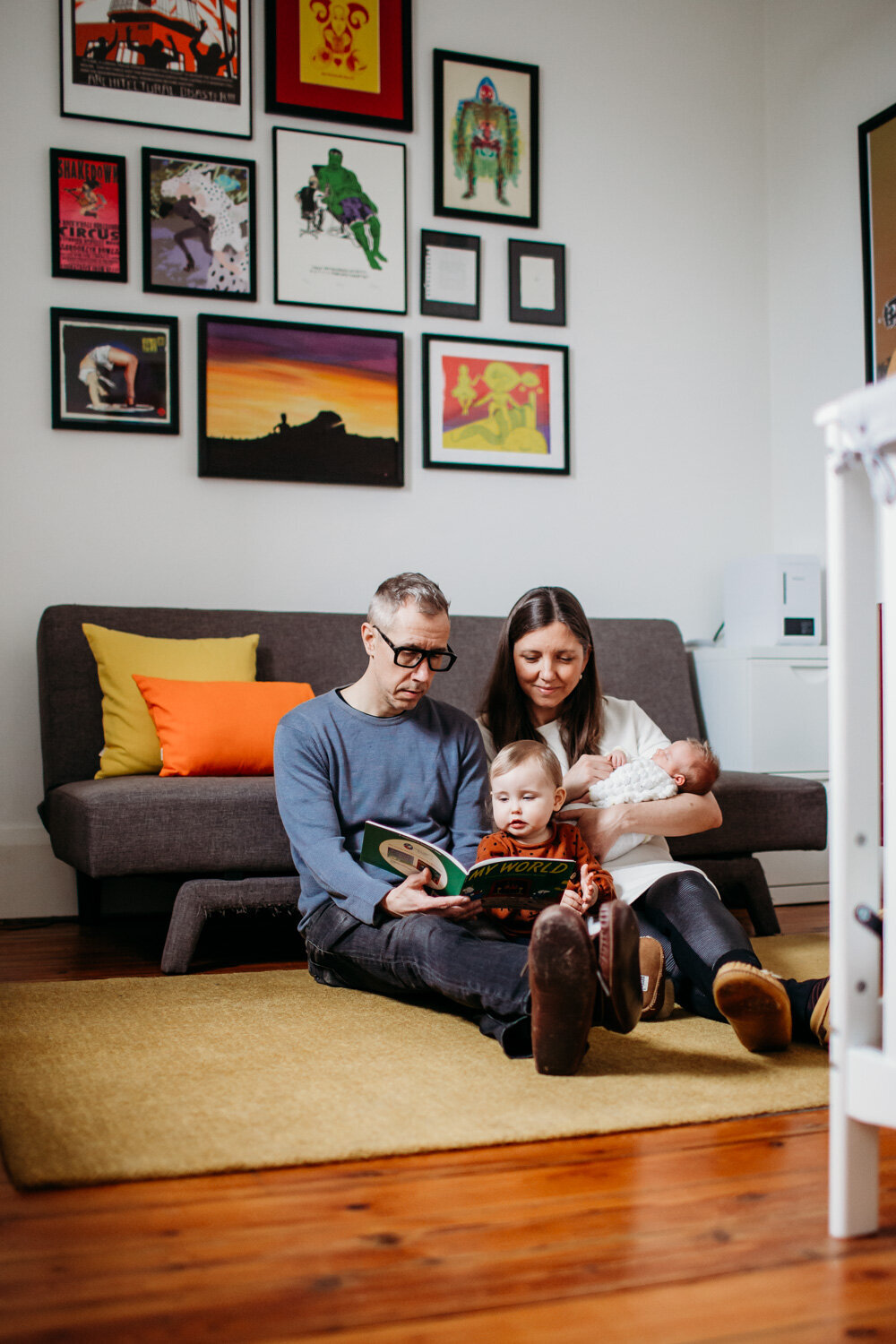 family reading story on Toronto nursery floor