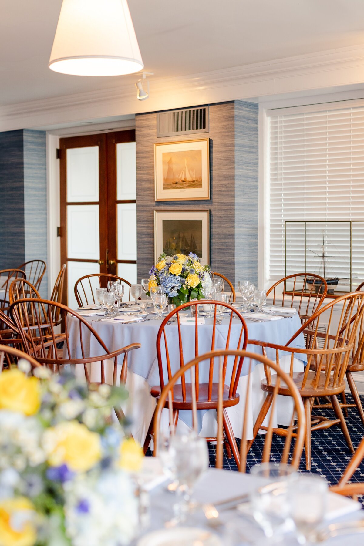 rehearsal dinner decor and table setting inside American Yacht Club in Rye, NY