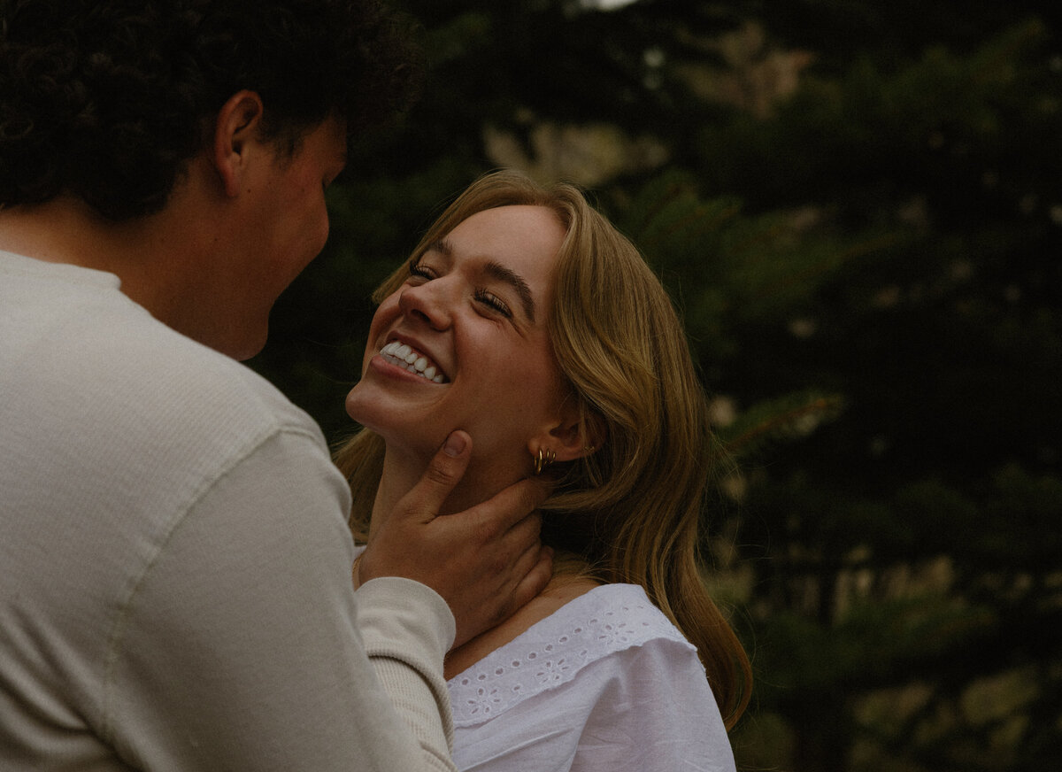 Dreamy winter couples engagement shoot in a snowy forest.