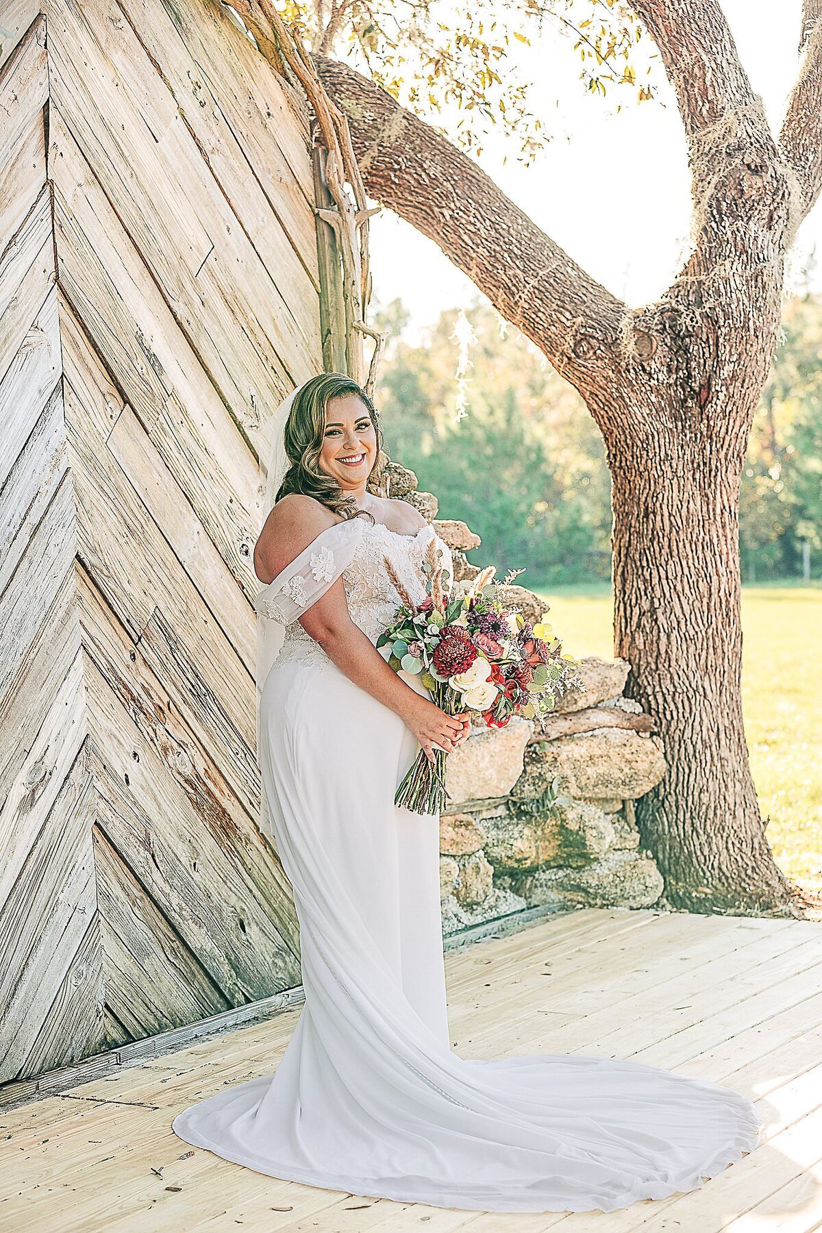 bride poses with bouquet at Bending Branch Ranch