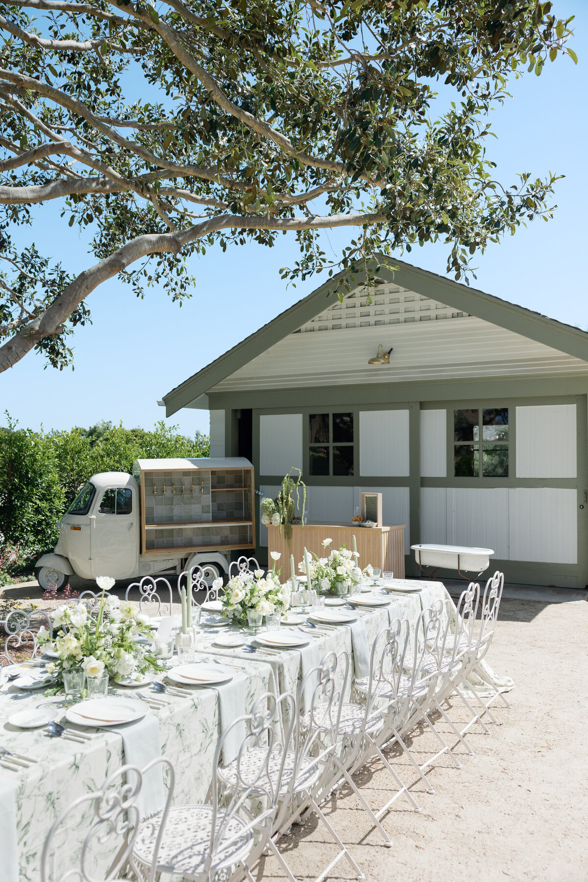 Long reception tables elegantly decorated with floral arrangements and fine tableware, showcasing the stunning venue details at a La Jolla wedding venue in San Diego, California.