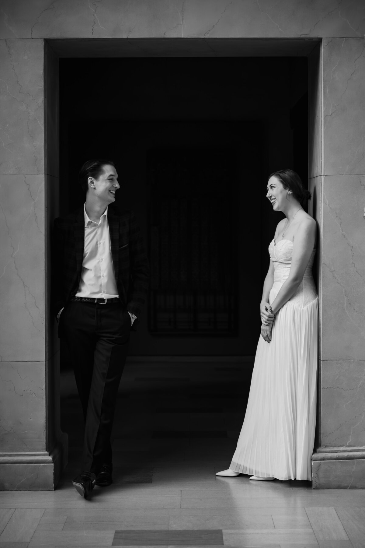 A couple stand on either side of a walkway.