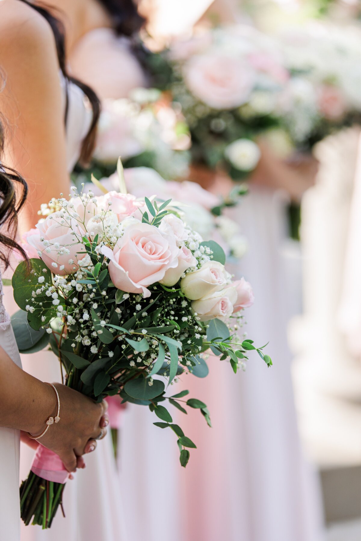 Close up of a bridesmaid holding a bouquet representing romantic Boston wedding photos