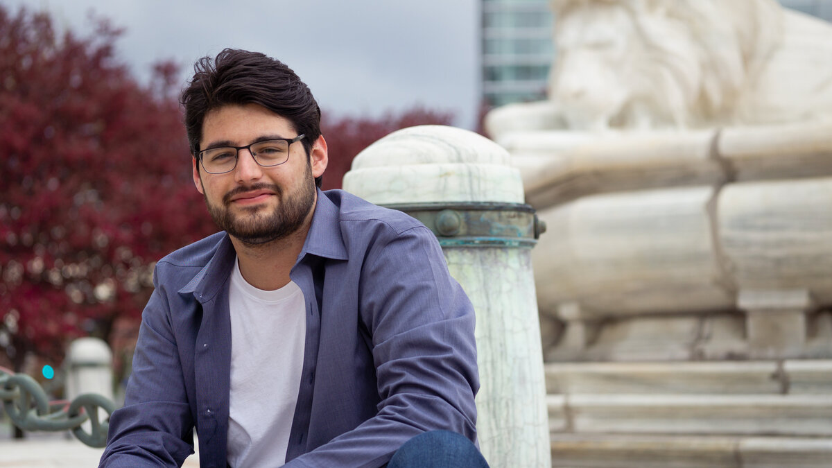 Professional headshot for a young man sitting in downtown Buffalo, NY