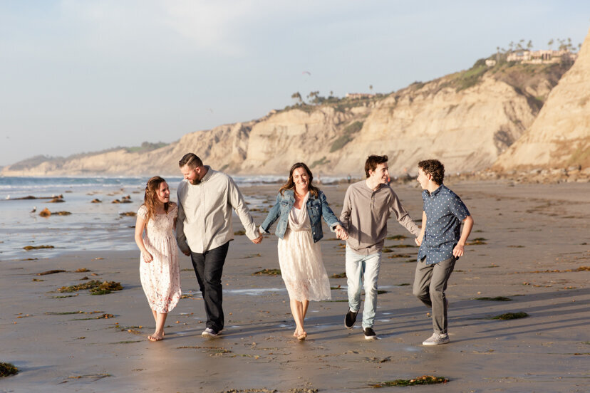 family-walking-on-la-jolla-beach-san-diego