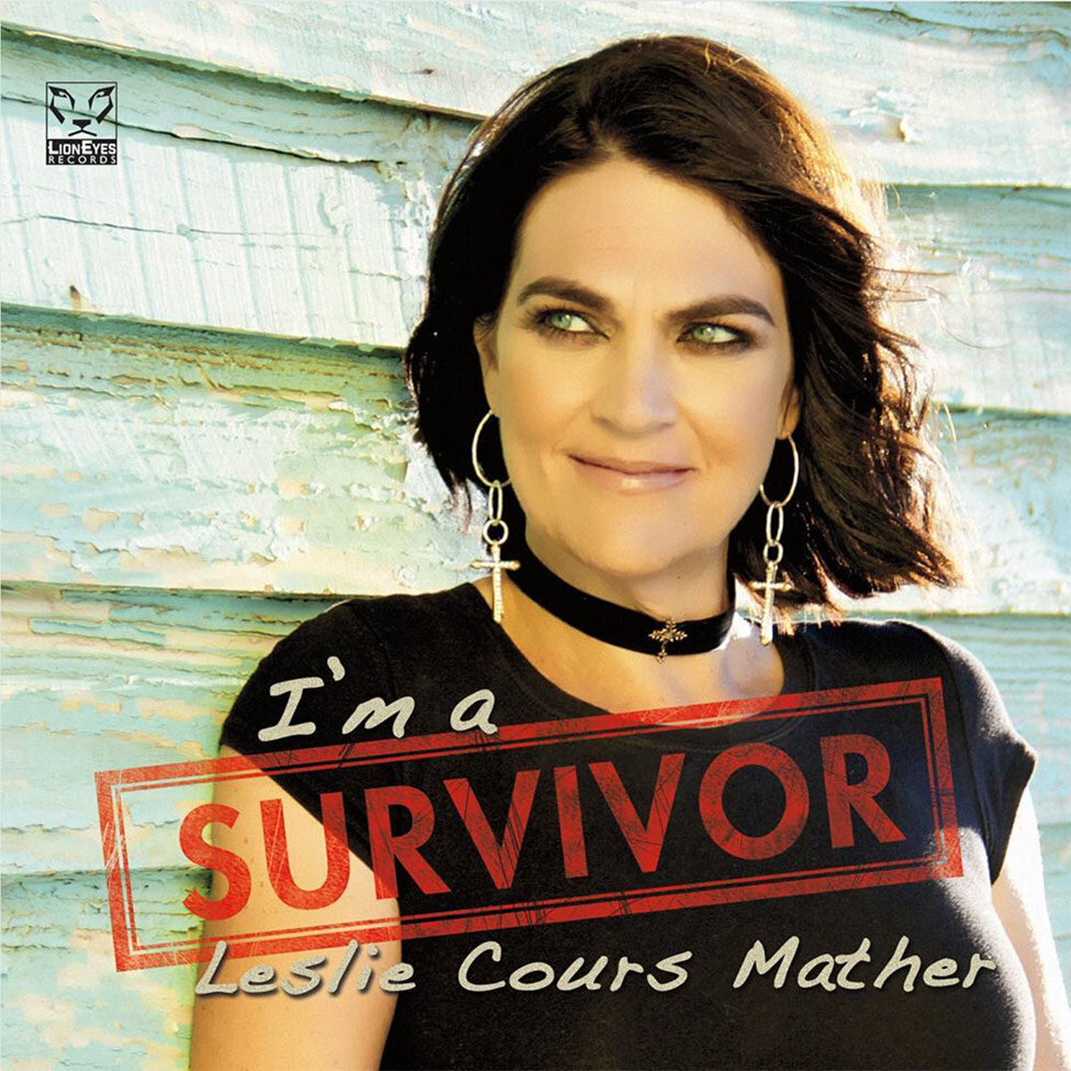 Album Cover Leslie Cours Mather standing against faded blue wood wall eyes looking off to side Title Im A Survivor
