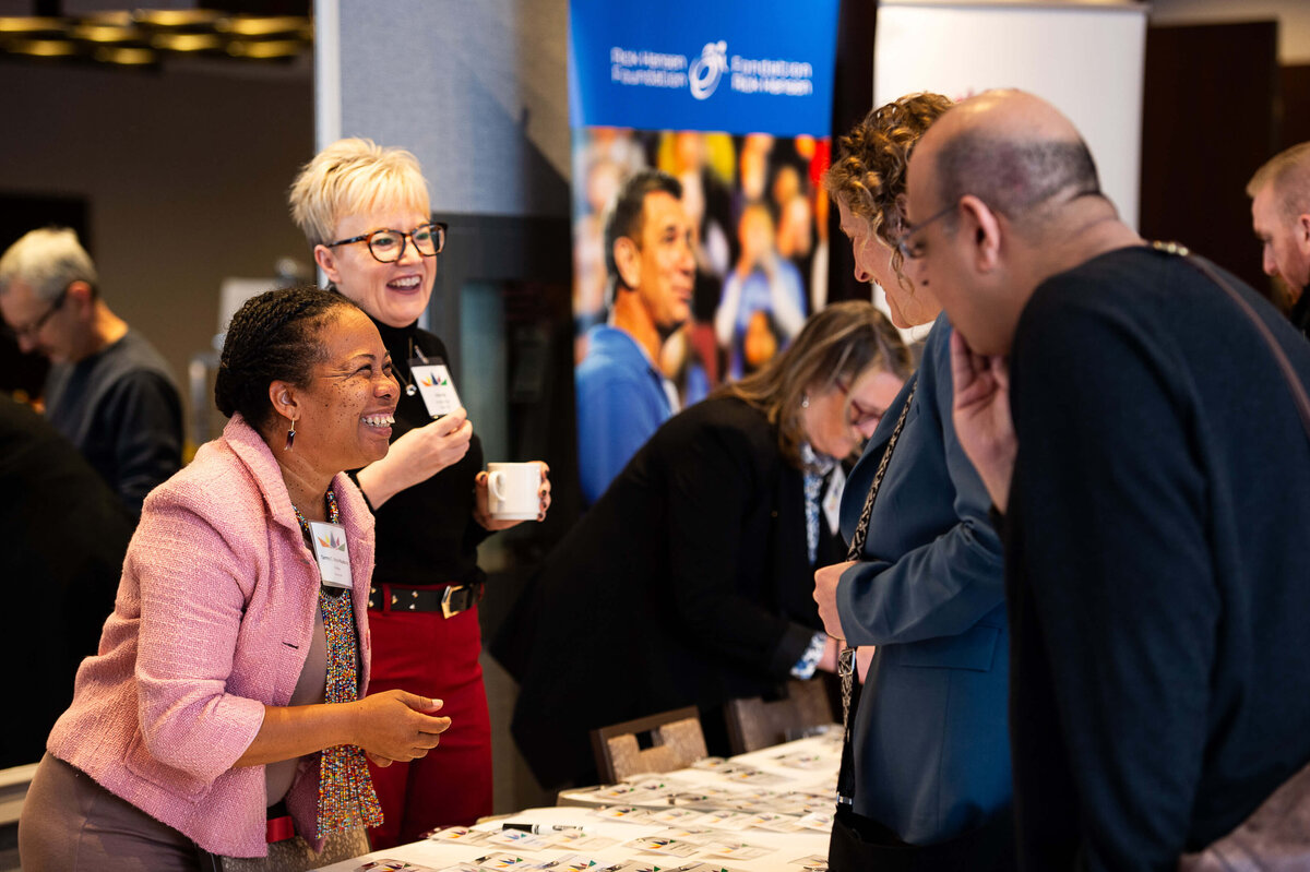 Ottawa event photos showing organizers meeting attendees during registration at the their conference.  Captured by Ottawa Event Photographer JEMMAN Photography COMMERCIAL