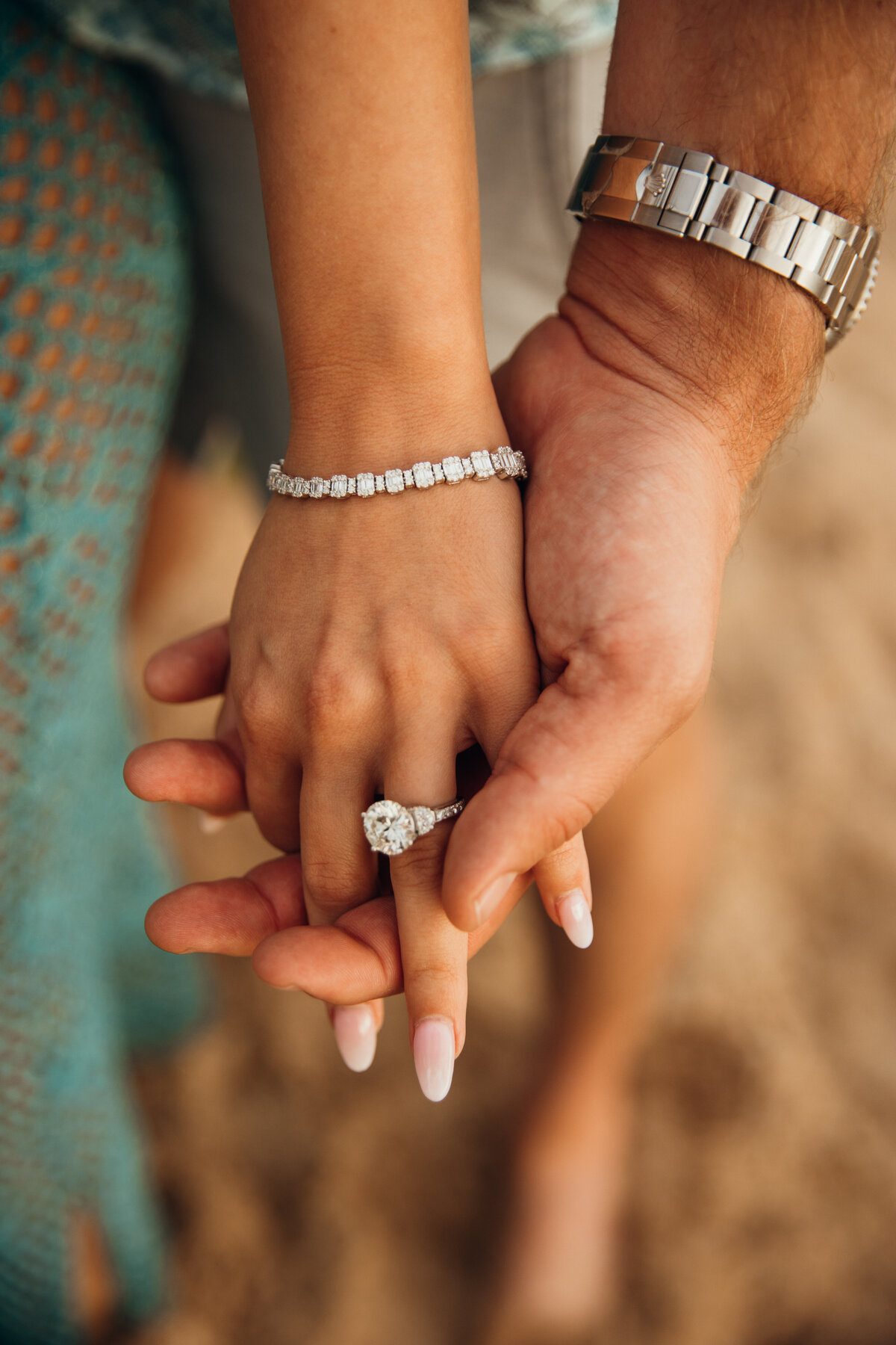 Hawaii Engagement Photographer captures close up of woman's engagement ring while holding partner's hand