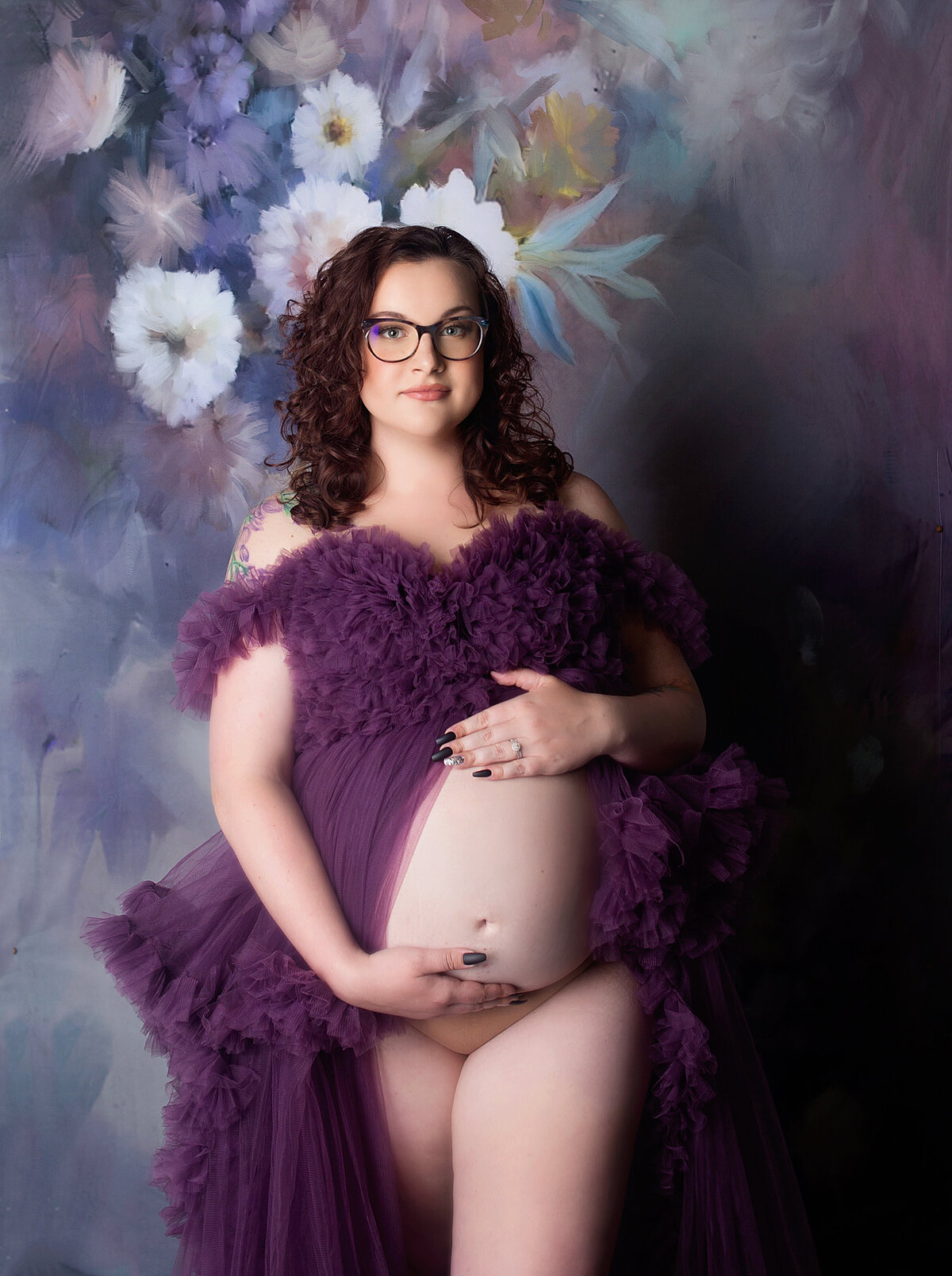 Women wearing purple maternity gown, with glam mkeup during maternity photoshoot in Franklin Tennessee photography studio