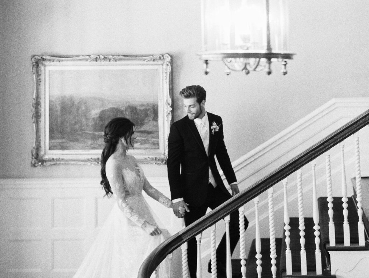 Bride & groom walking up stairs in a  luxury  palace