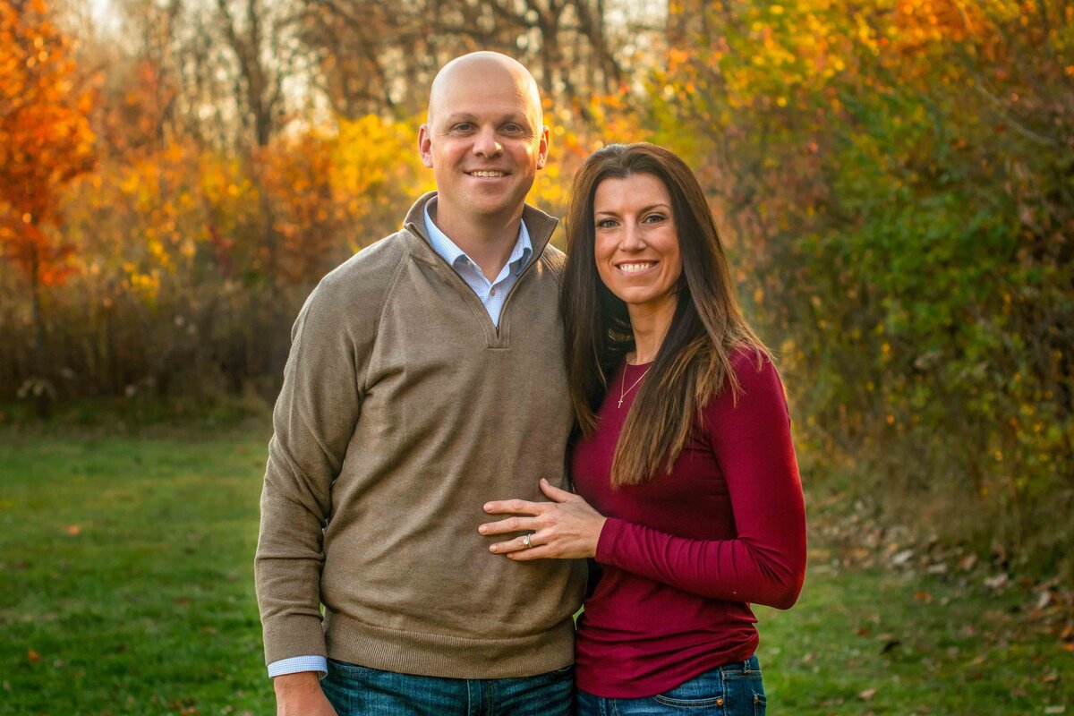 Couple with Fall leaves in background Ritchey Woods Fishers