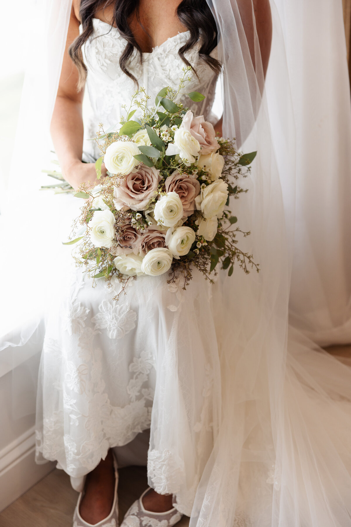 Detail Shot of Bridal Lace Dress and Neutral-Toned Wedding Bouquet