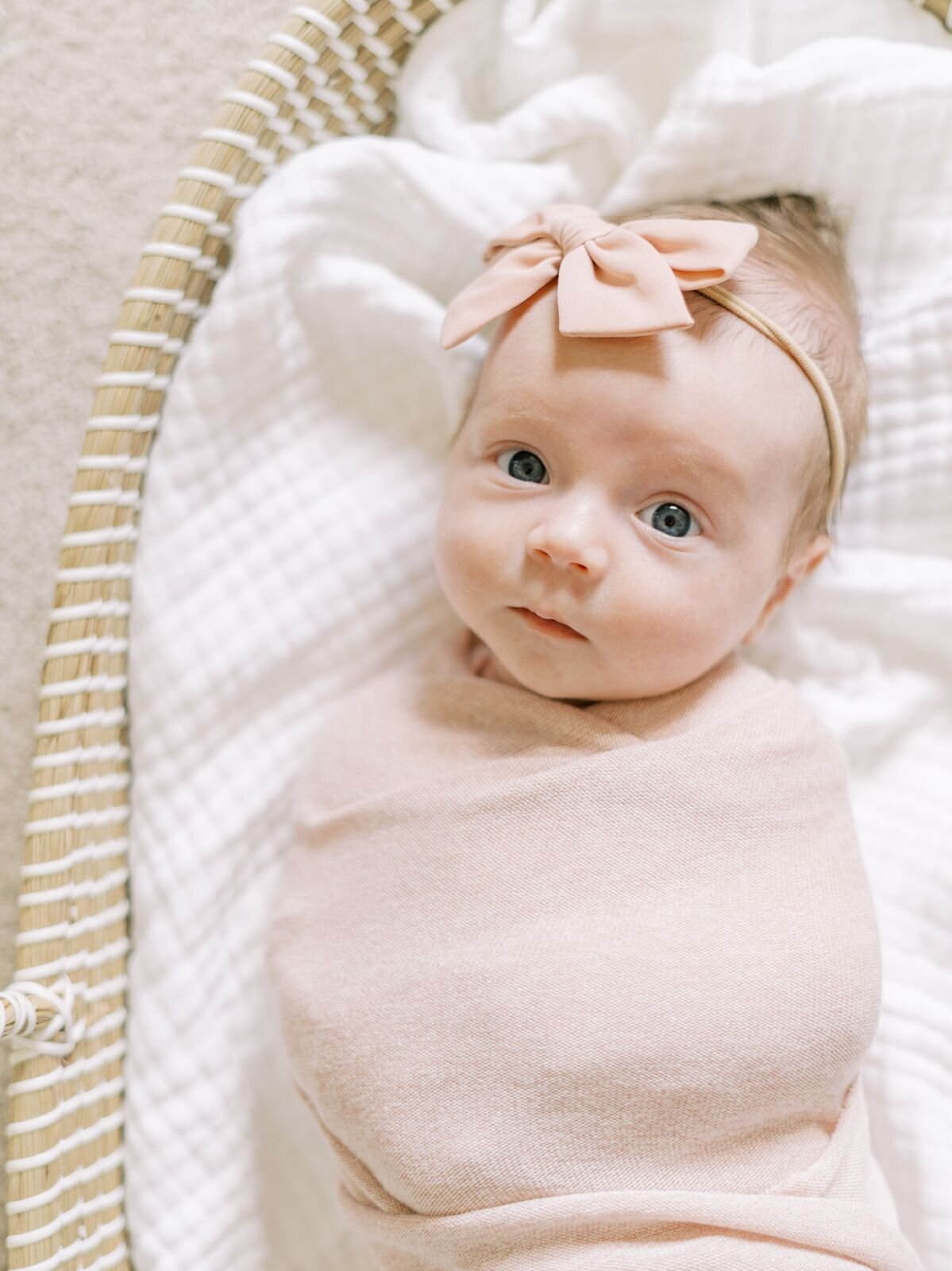 Newborn Photos of Baby Girl wrapped in pink at Dallas Photography Studio