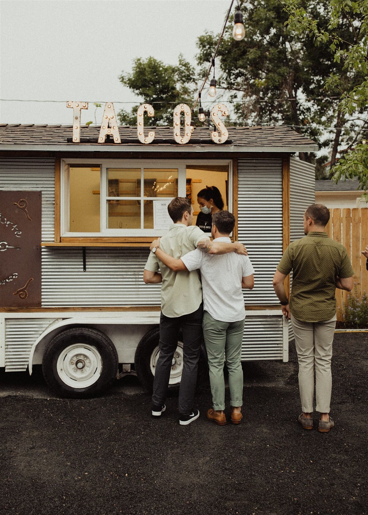 Guests at Taco truck at rehearsal dinner at the Terry Guesthouse, a micro wedding venue at historic home in Longmont, Colorado