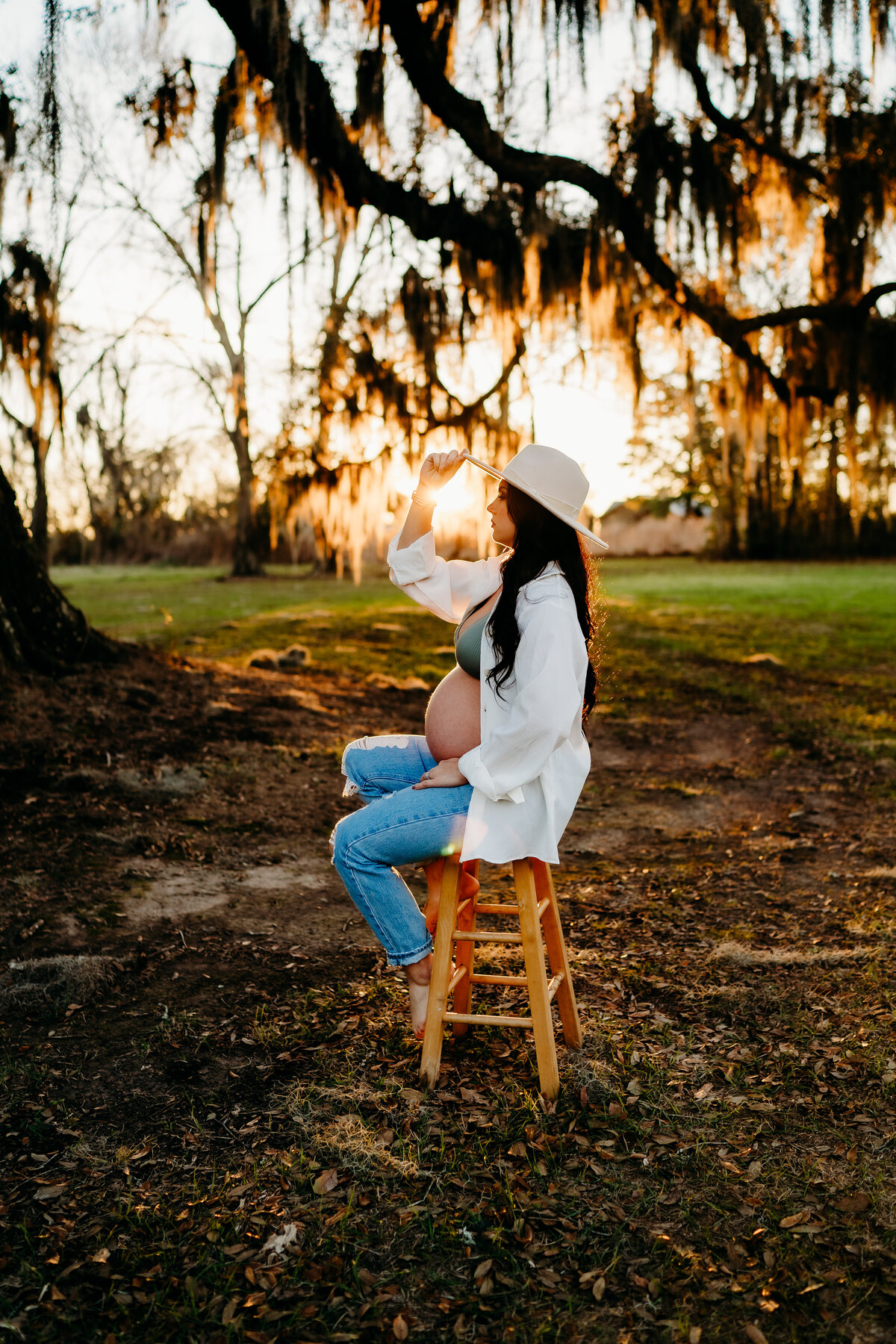 Sunset photos for pregnancy shoot with unbuttoned shirt and jeans in new Iberia, la