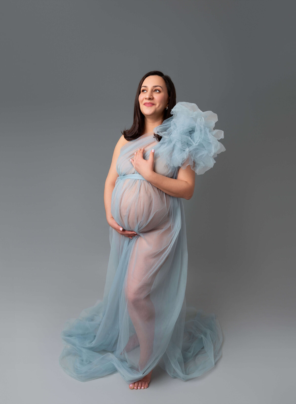 NYC modern maternity photographer captures mom to be in a stunning blue tulle gown