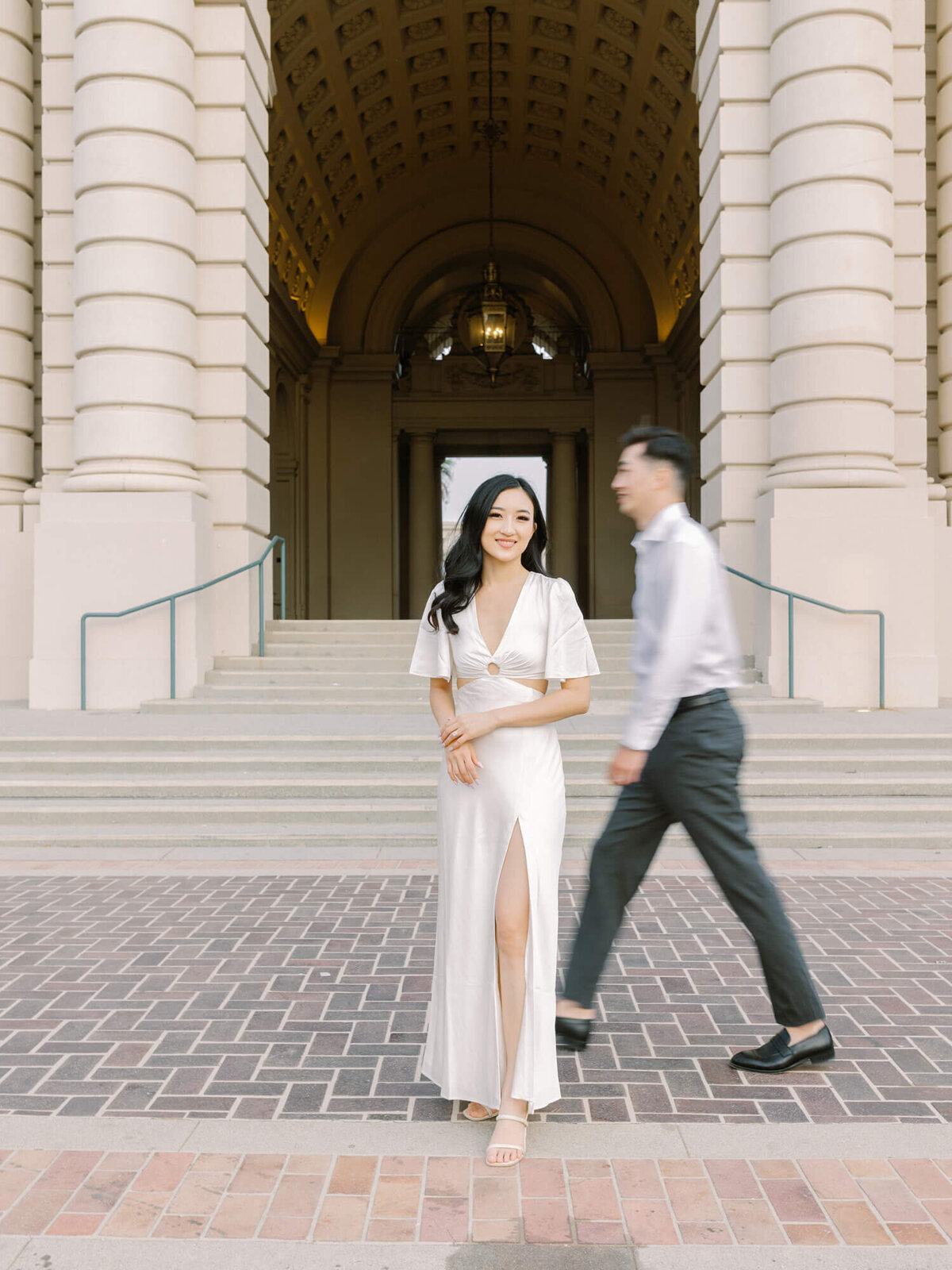 engagement photo of couple at the back side of pasadena city hall with brick floors