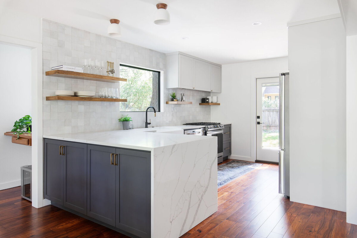 hello-home-two-tone-cabinets-kitchen-remodel-hardwood-flooring-waterfall-peninsula-zellige-backsplash-austin-3