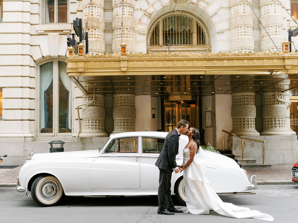 bride and groom with vintage limo rolls royce outside belvedere hotel baltimore