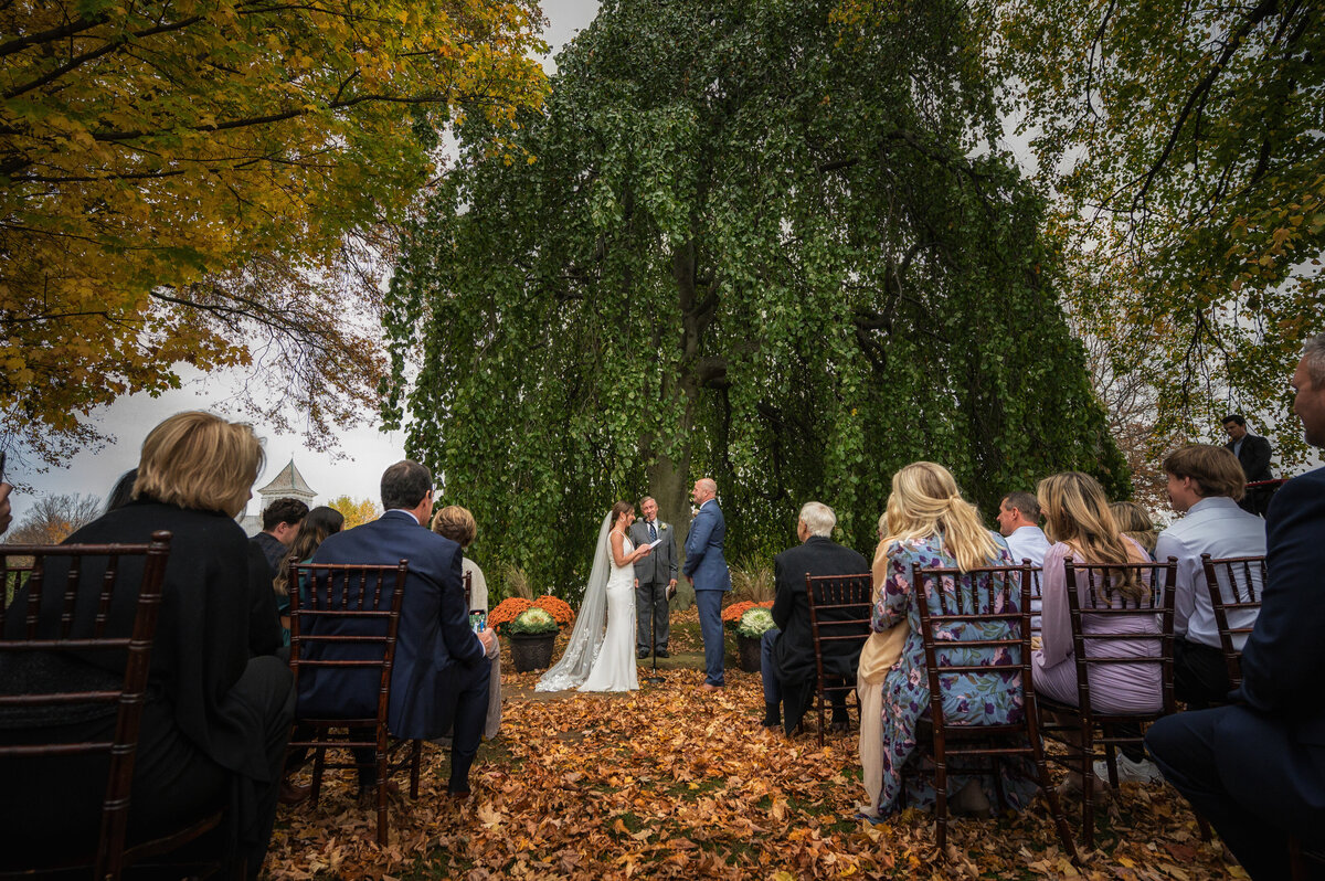 Outdoor wedding ceremony during fall.