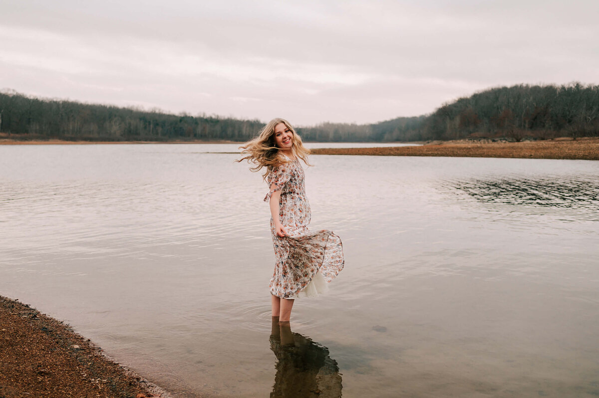 Branson Missouri senior photography of senior girl twirling in the water
