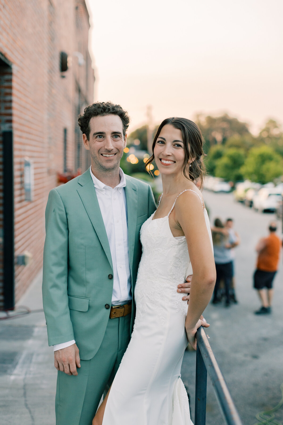 Brendan and Sara embracing outdoors during golden hour portraits outside Fetewell in Baltimore.