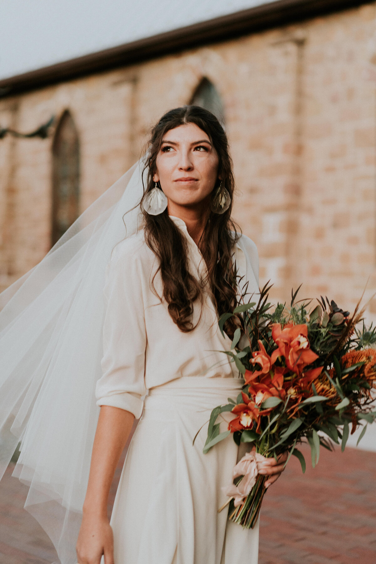 Bride with her southwestern boho bouquet .