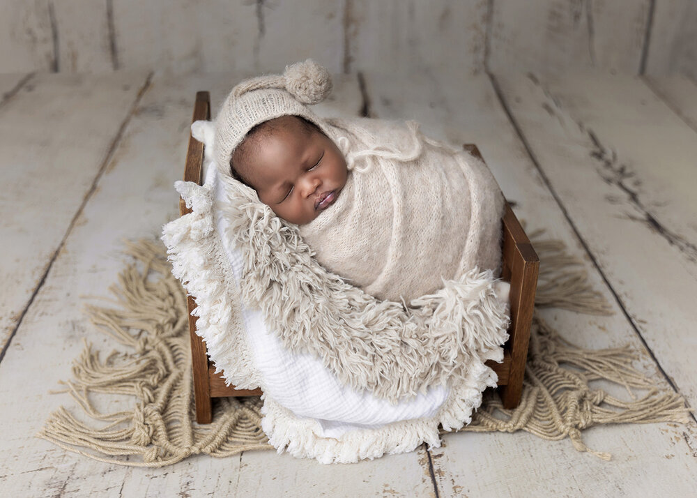 NEWBORN_BABYBOYWRAPPEDINWOODENBEDWITHHAT