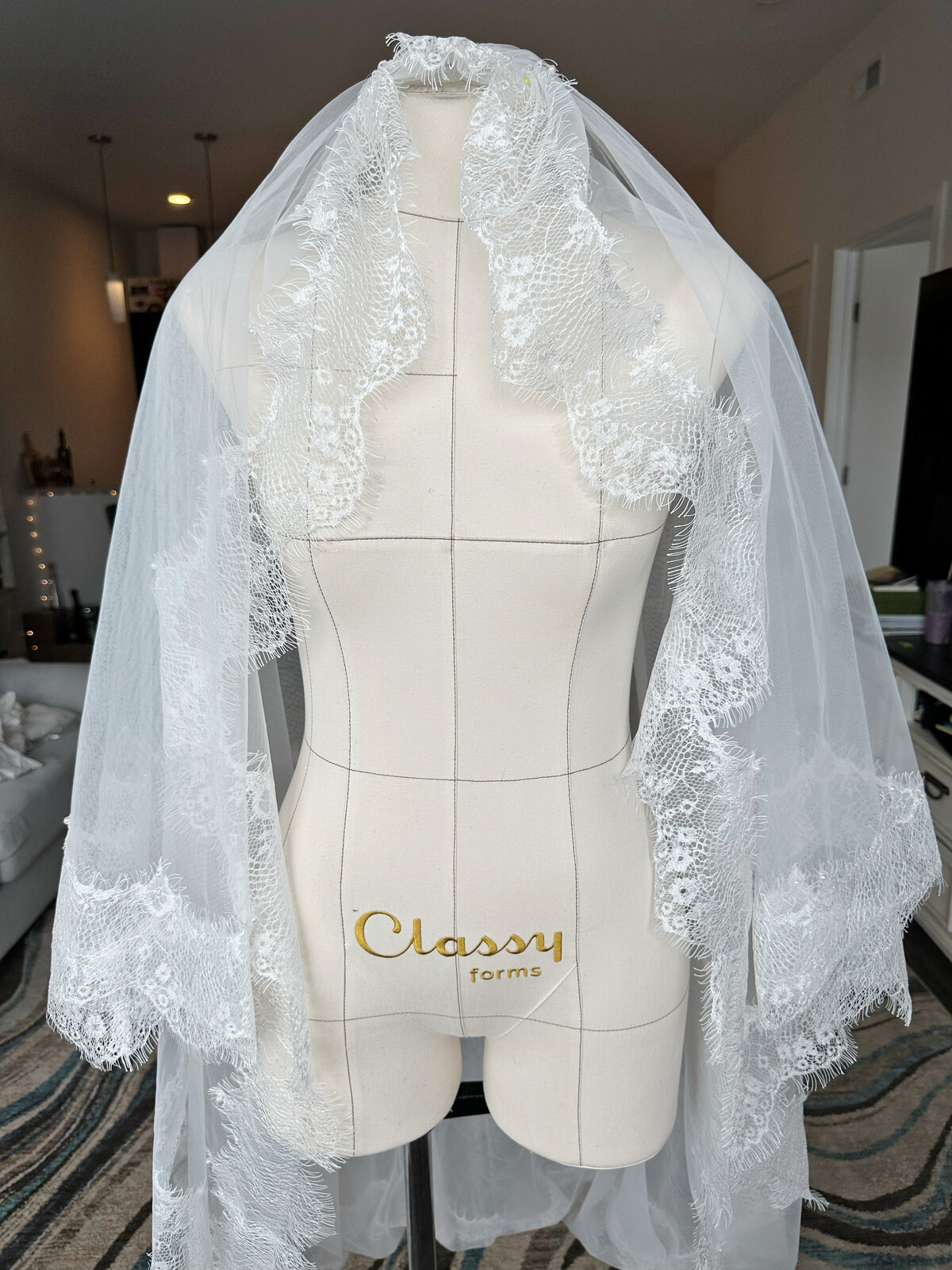 Floral lace blusher veil flowing gently over bridal gown
