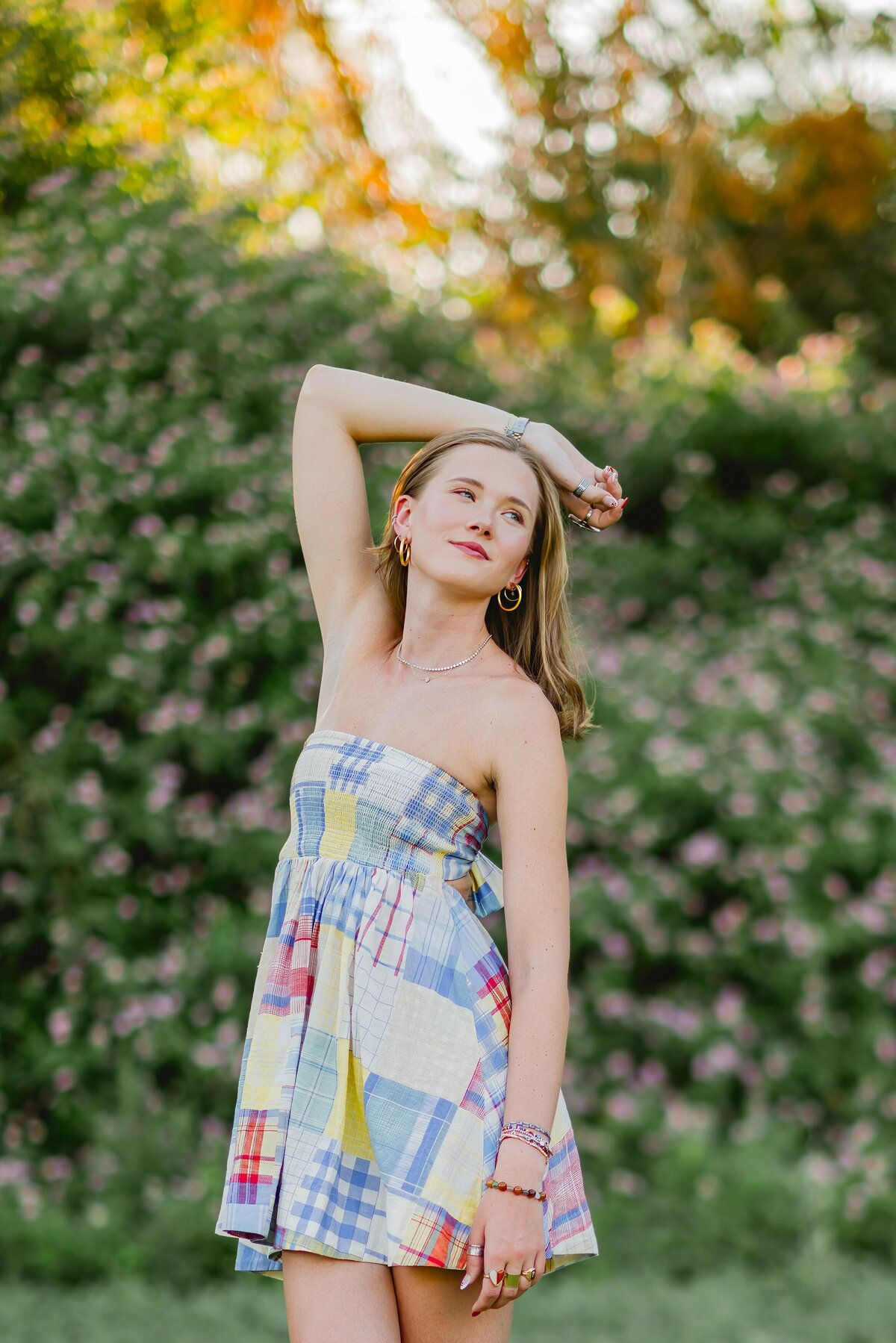 senior girl hand over her head looking over her shoulder
