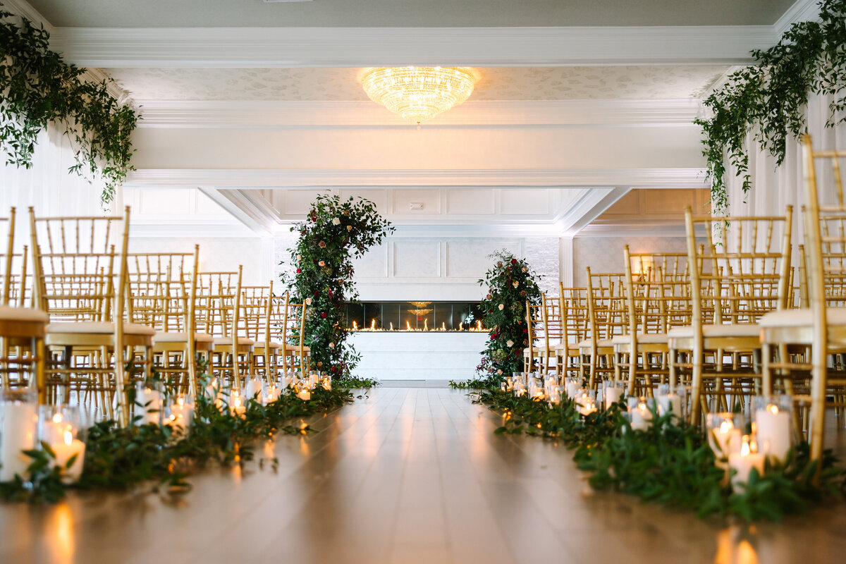 Wedding aisle with candles and greenery on either side
