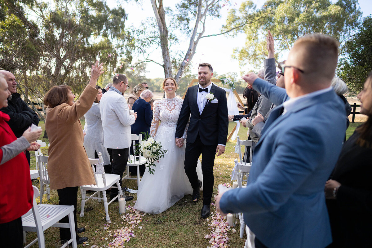 Couple walking back the aisle after their wedding
