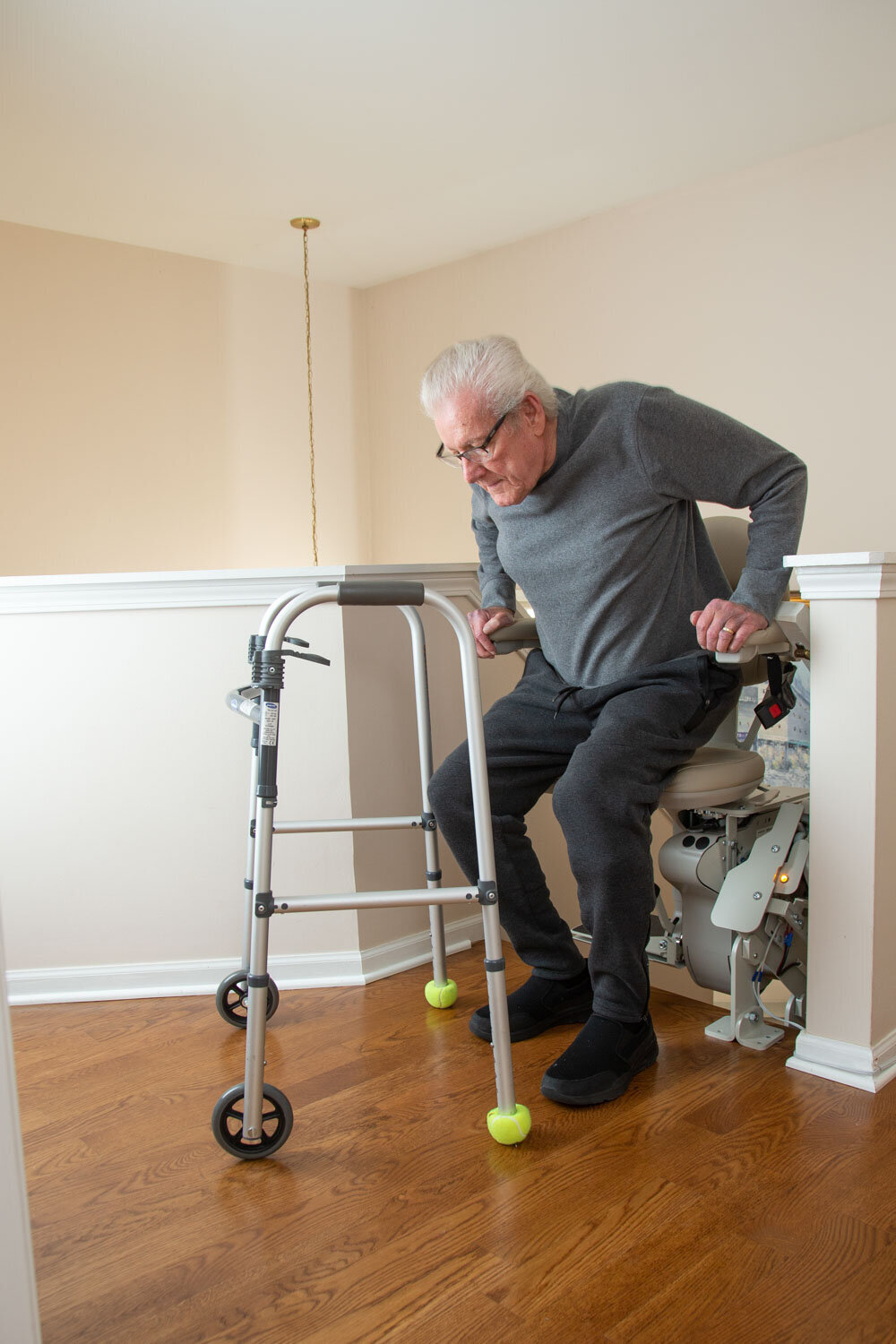 A man with a walker is sitting in a chair