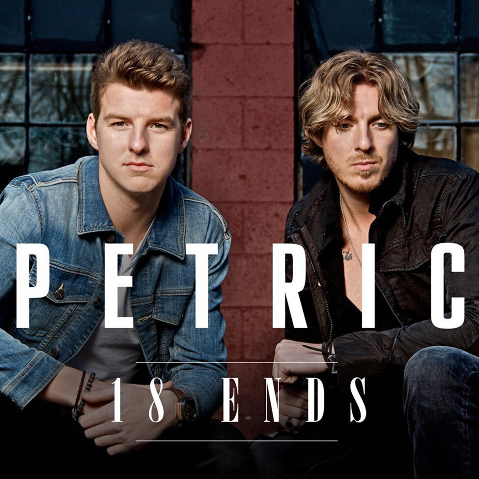 Album Cover music duo Petric Titlemembers sitting on either side of red brick column 18 Ends band