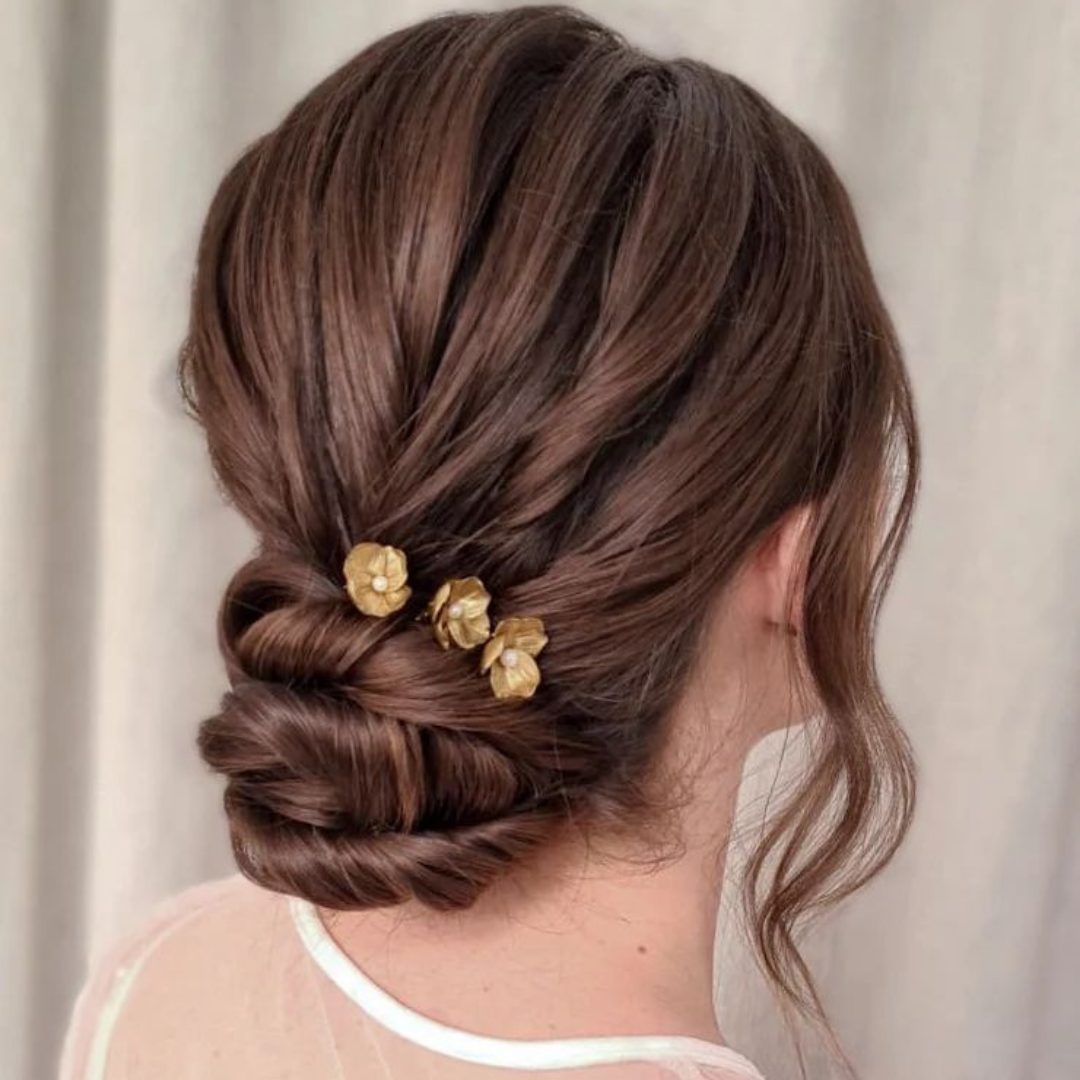 Relaxed up style on Brown hair wearing a gold flower hair piece