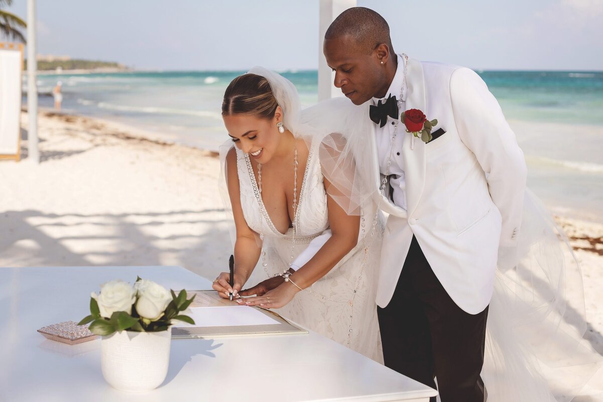 Bride signing wedding certificate at wedding in Riviera Maya