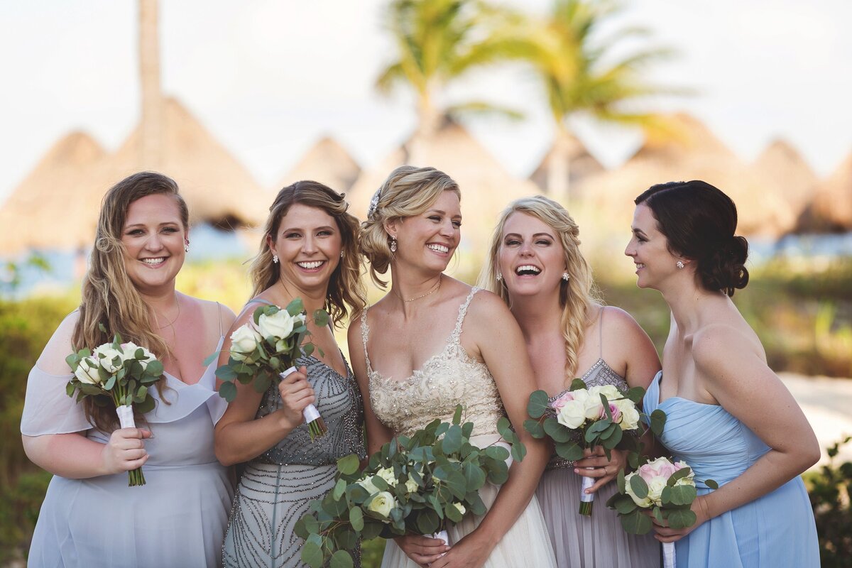 Bride and bridesmaids laughing at wedding in Cancun