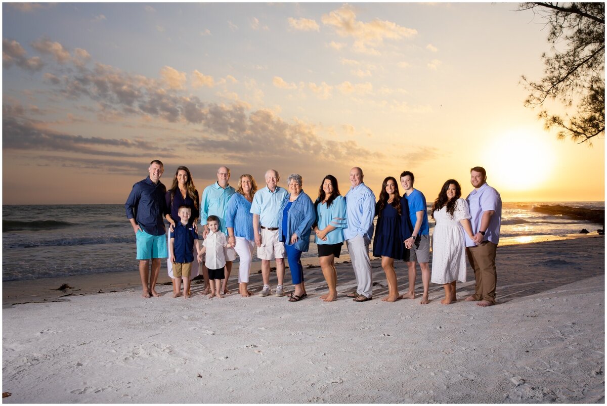 An extended family of fifteen vacationing together at the beach