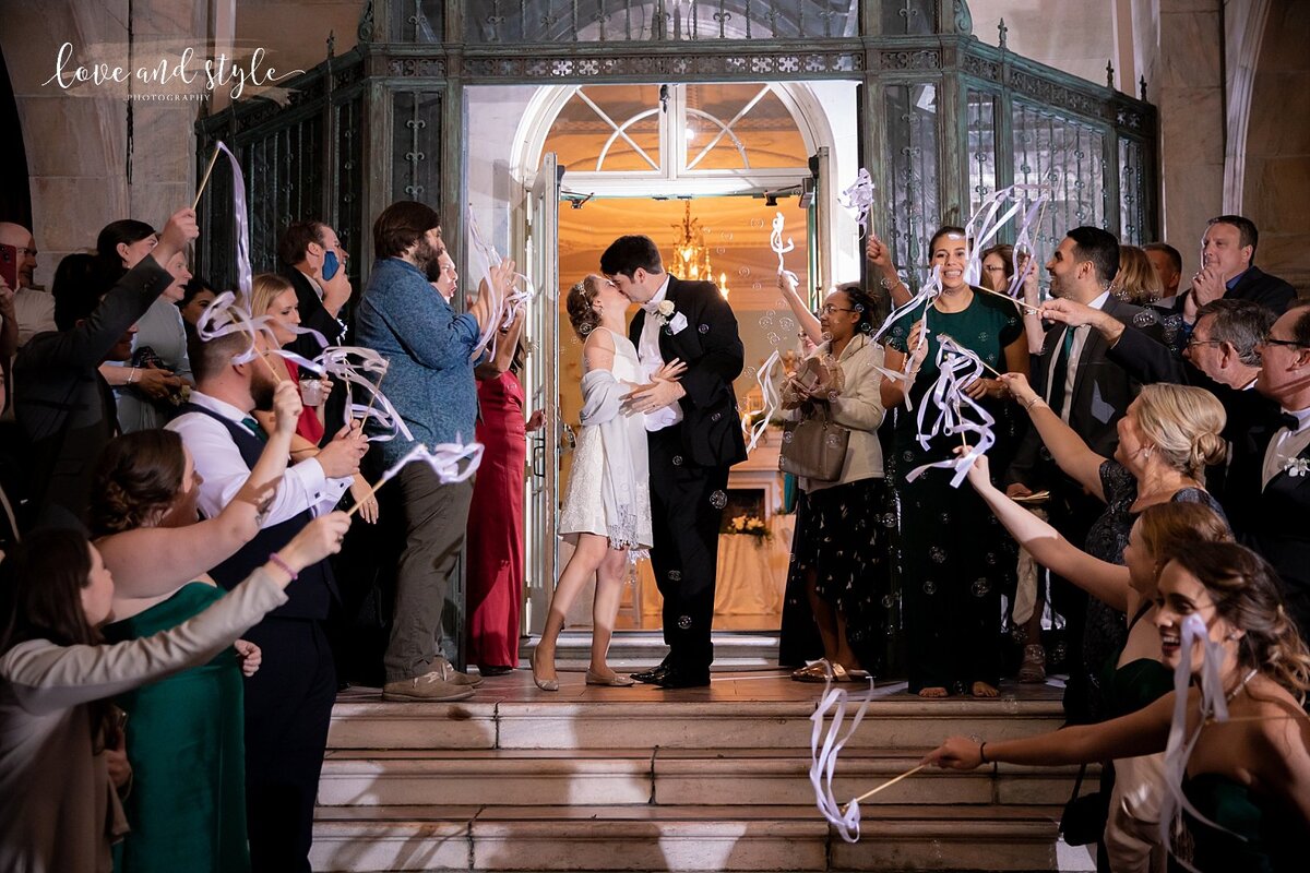 Bride and Groom on the stairs at New College, Sarasota during their grand exit taken by Love and Style Photography