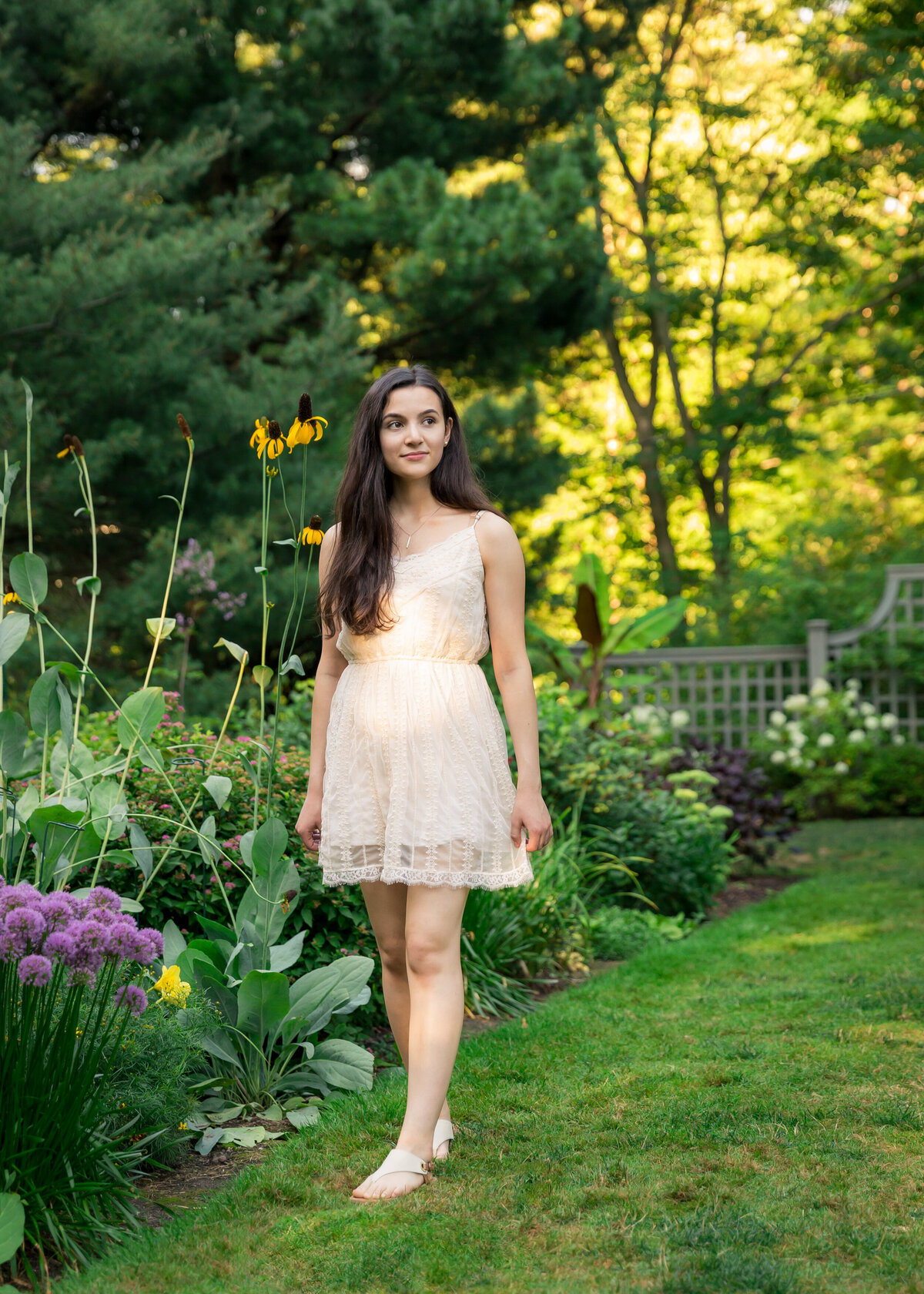 Beautiful Senior pictures taken at Warner Castle by flower garden in Rochester, NY