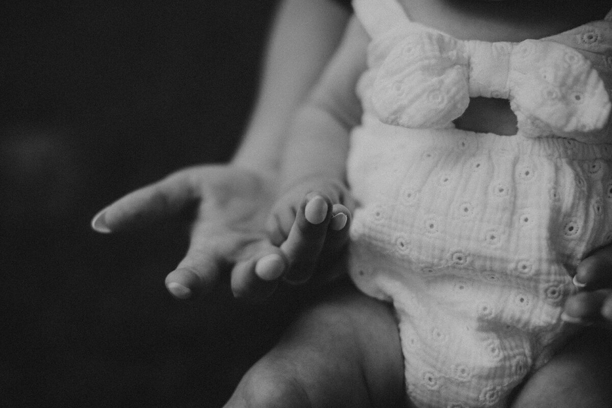 black and white photo of mom holding daughter's hand 