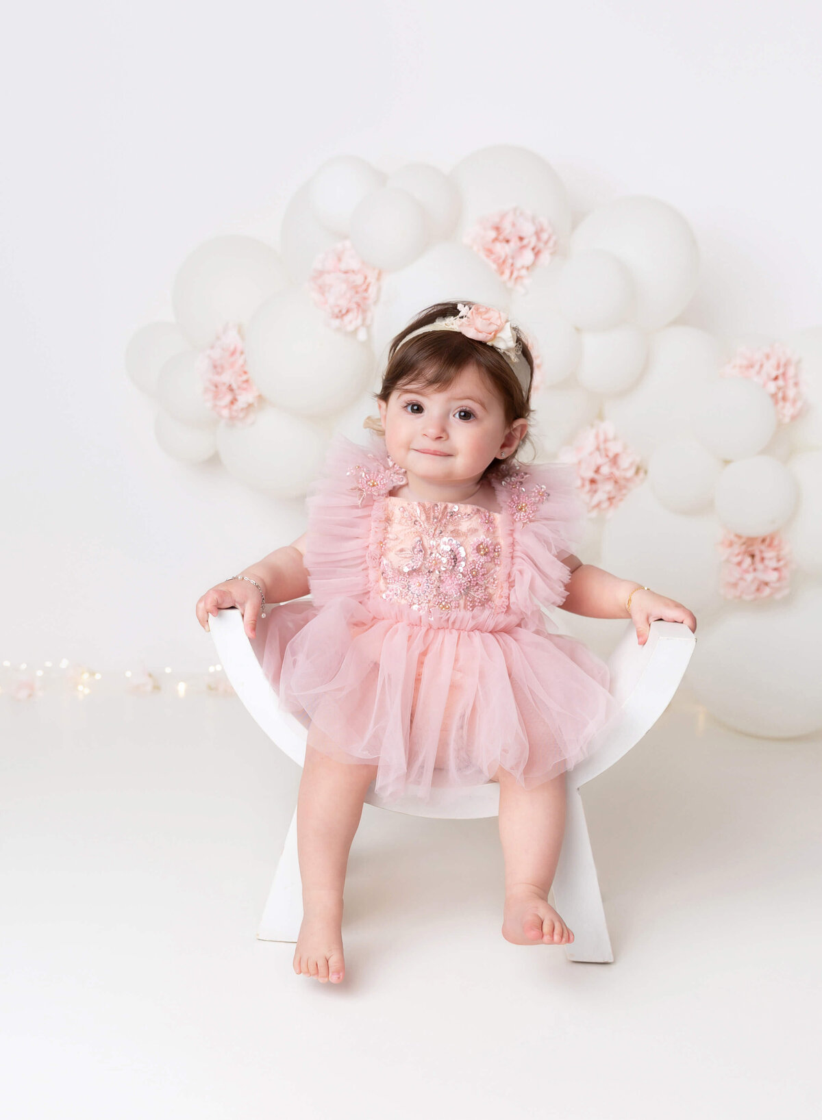 Baby photography in Brooklyn Pastel  pink and white balloon garland in New york city cake smash photographer