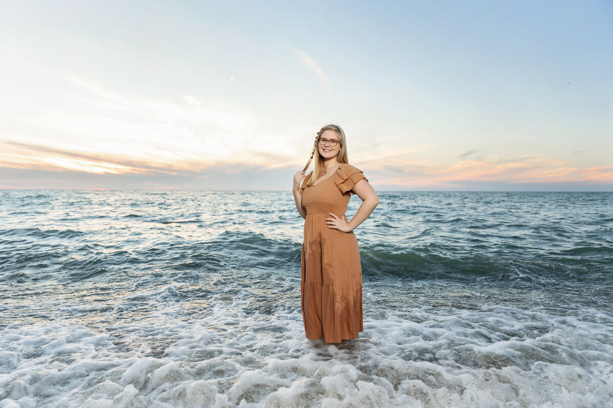 Senior portrait of a girl standing in the water at Presque Isle State park in Erie Pa