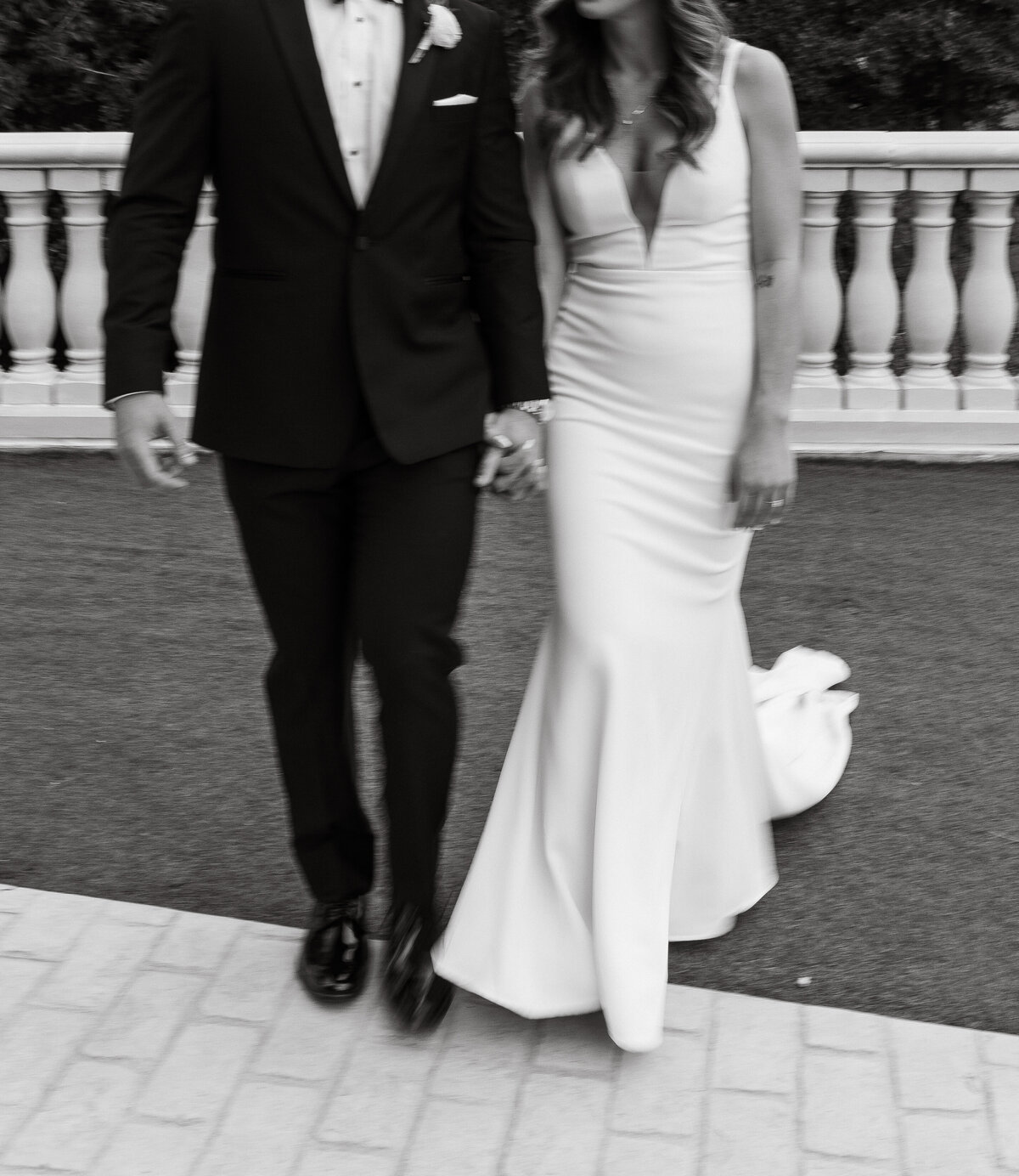Wedding Photographer & Videographer, black and white image of bride and groom walking together
