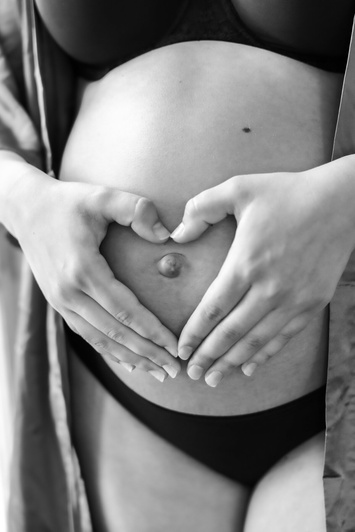 hearts made of hands held over a cute baby bump . Photo taken at The Aitken Estate in Flint, MI 