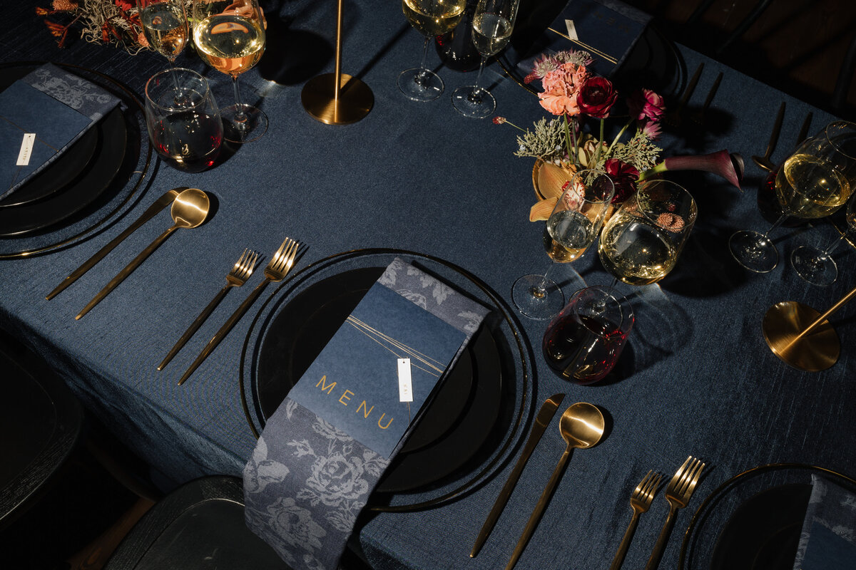 Moody navy blue wedding tablescape with Daffodil Parker, Fest Paper, Valerie Halling, and Event Essentials