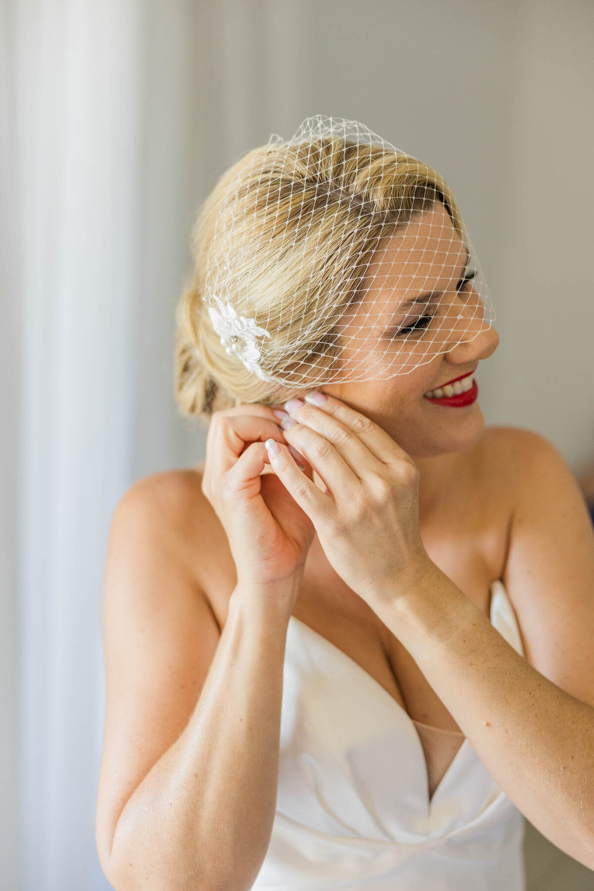 bride put in her earring on her wedding day