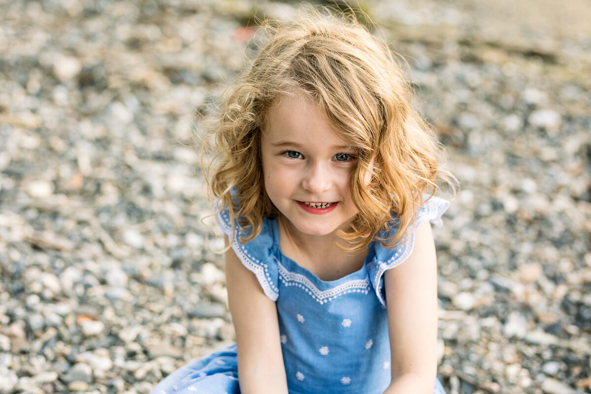 4 yo girl sitting on the beach in a sundress Burlington Vermont Photographer