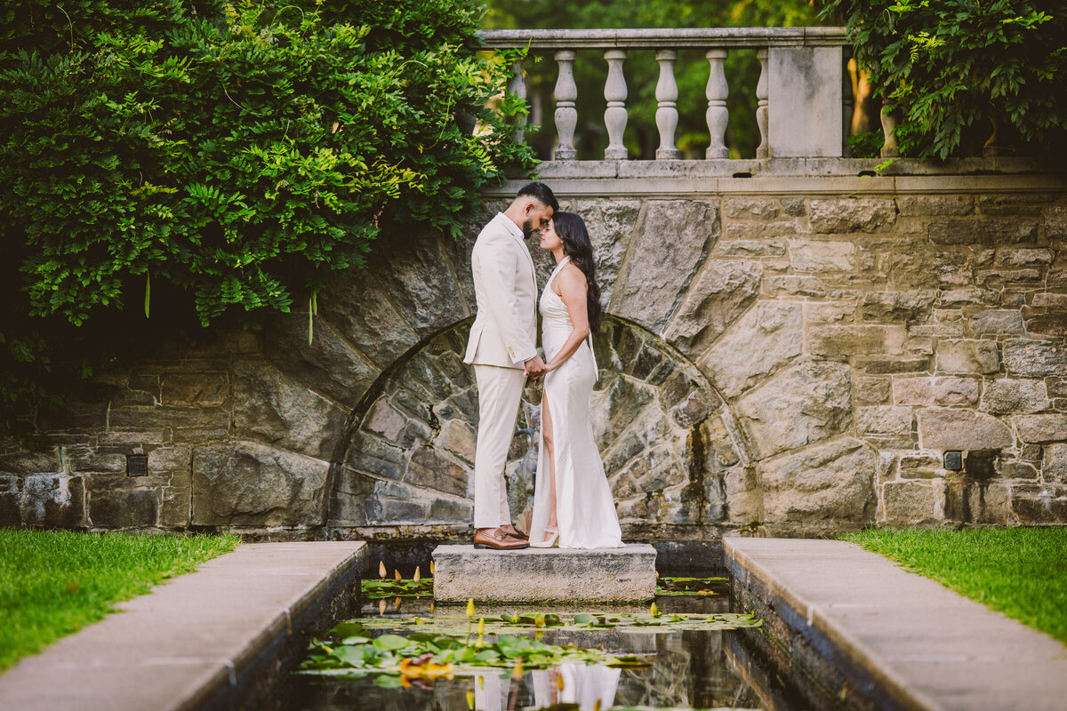 A couple sharing a moment on a pond at the nj botanical garden at ringwood state park during their engagement