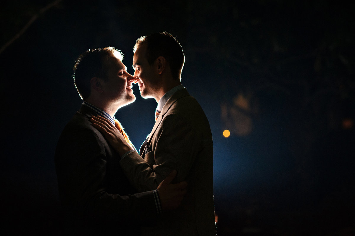 Two grooms share a kiss after their wedding at the patapsco female institute.